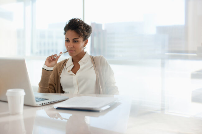Woman filling out paperwork for compliance.