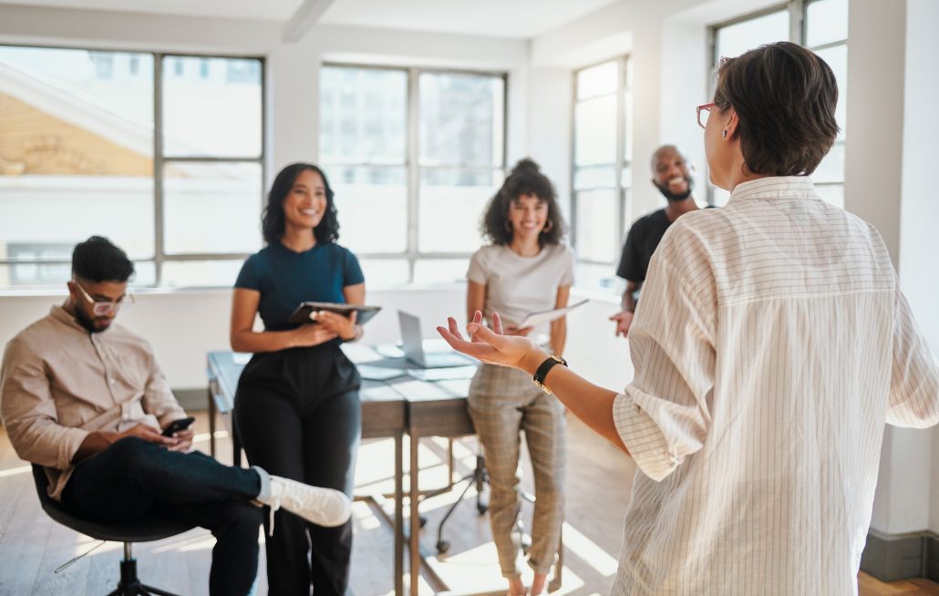 Presentation, communication and business leader with team in discussion, conversation or talking about marketing strategy. Meeting, collaboration and employee writing notes for company success goal