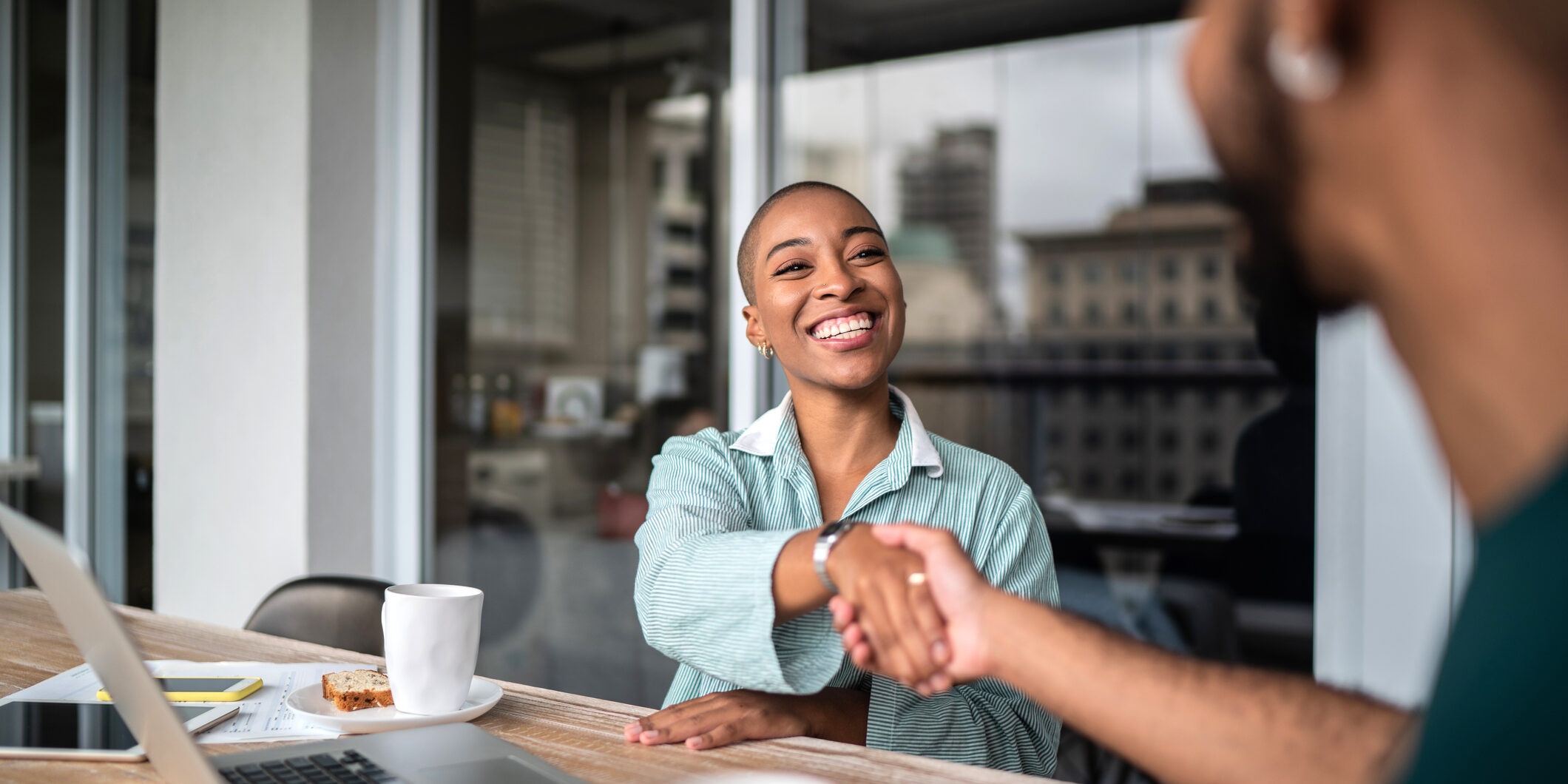 Interview handshake between two people.
