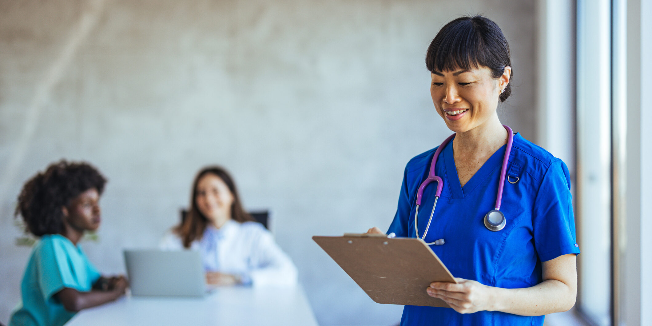 Friendly Nurse Writing Notes in a Hospital Meeting Room